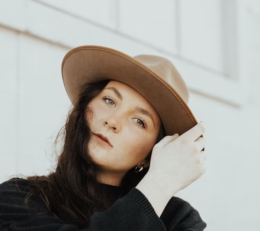 Woman wearing brown fedora hat